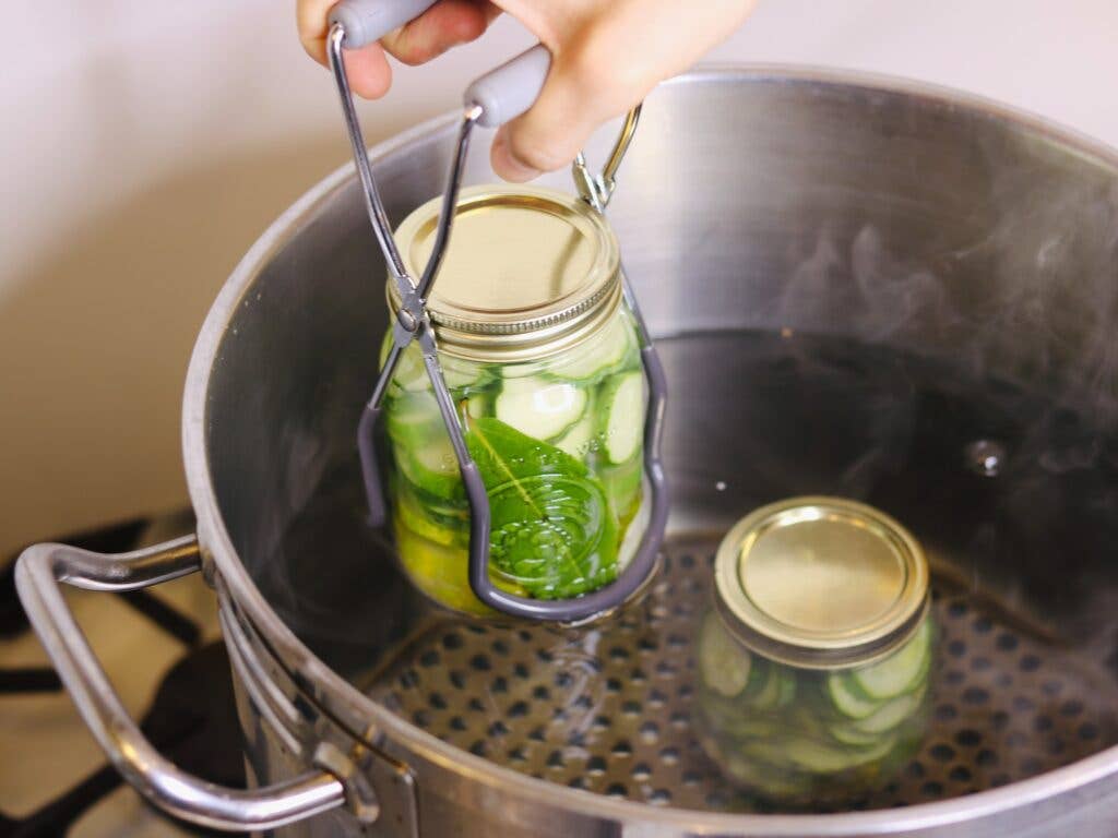 Placing jars in boiling water