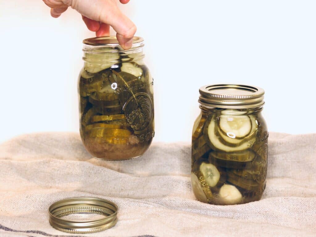 Testing lid seals for canning by picking up jars