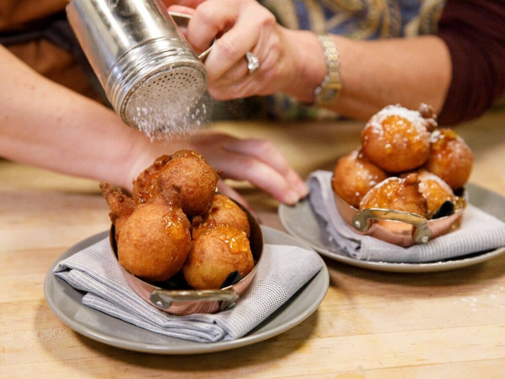 Powdering donuts with sugar for Hanukkah