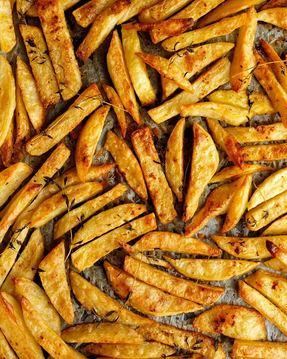 Seasoned fries on a baking sheet.