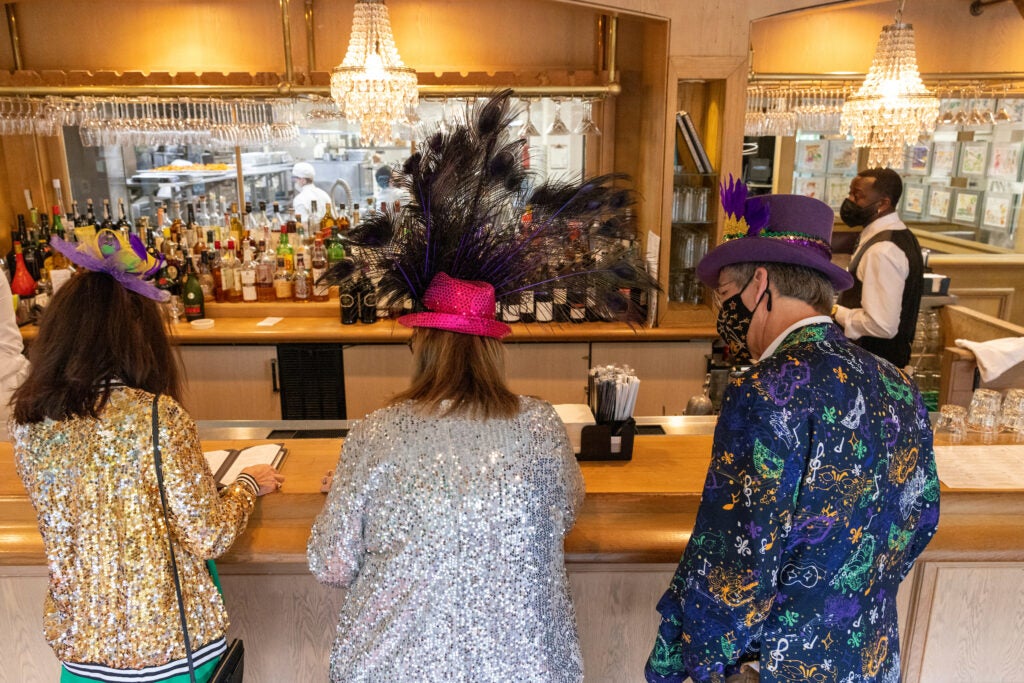 mardi gras revelers eating at commander's palace