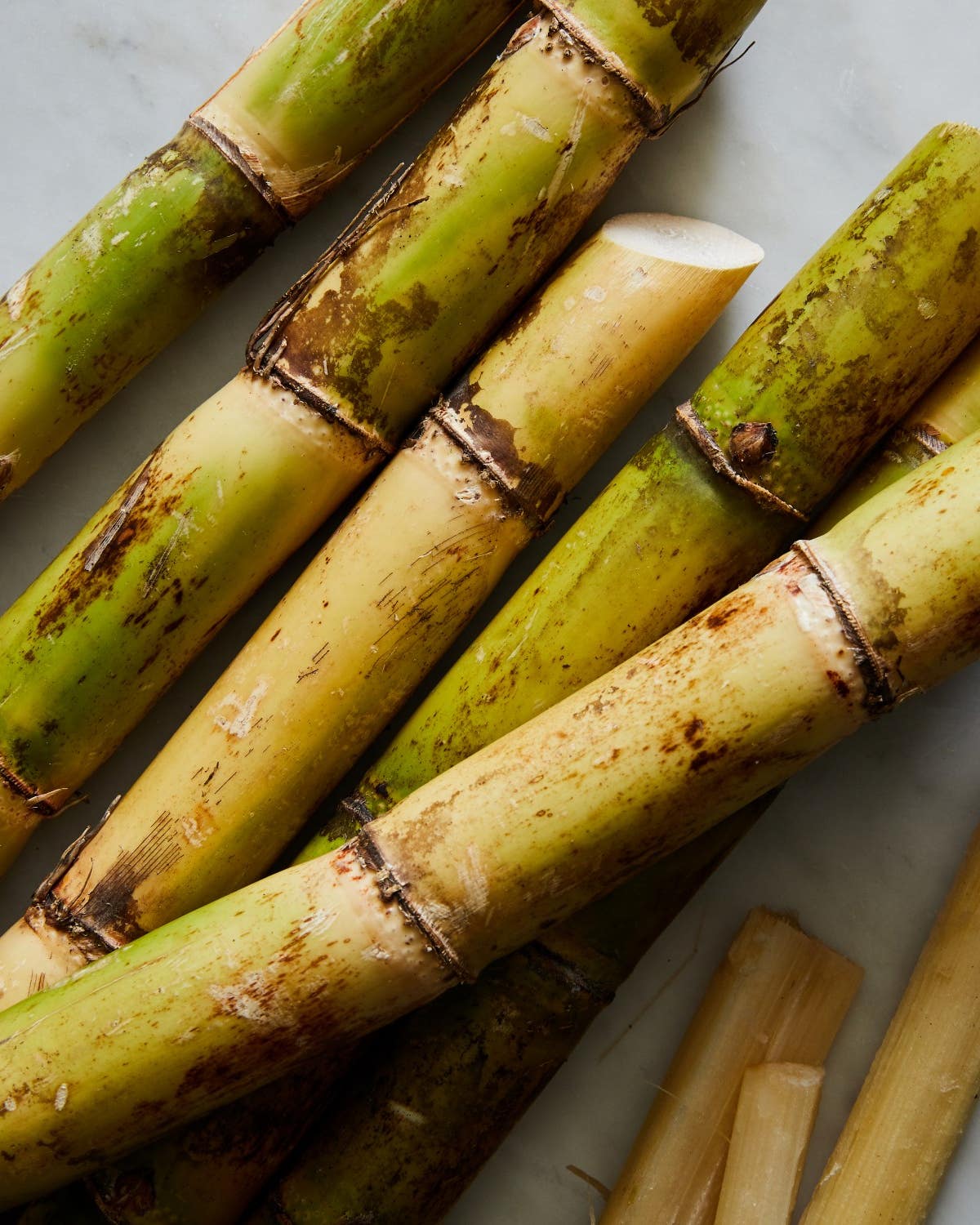 Reclaiming Sugarcane From Its Dark History to a Sweet—and Healthful—Drink Sugarcane Ingredient on Marble Background