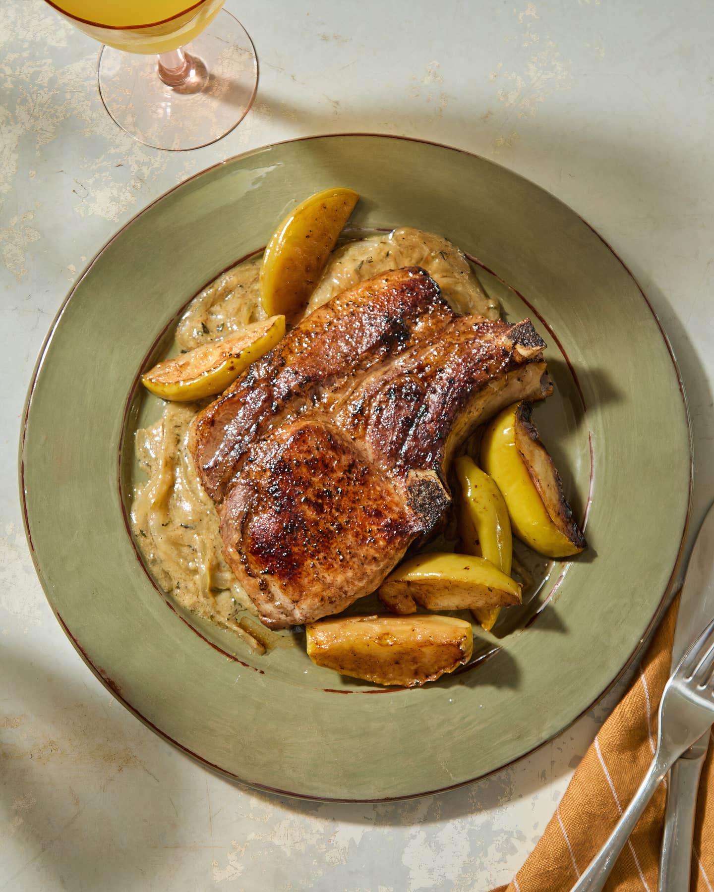 Pan-roasted pork chop with apples and mustard-onion gravy
