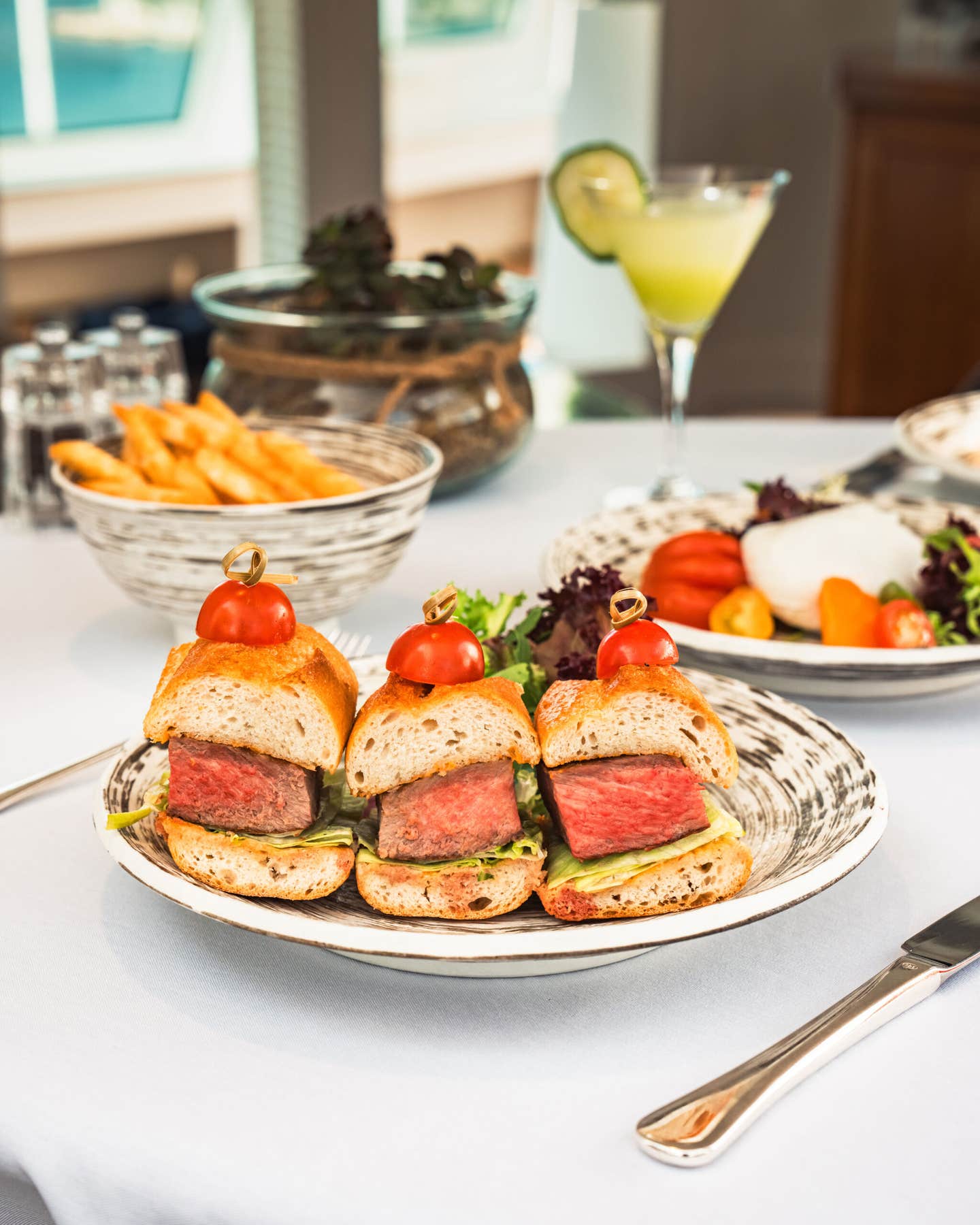 Steak sandwiches and cocktails for lunch in the Retreat aboard Seabourn Encore.