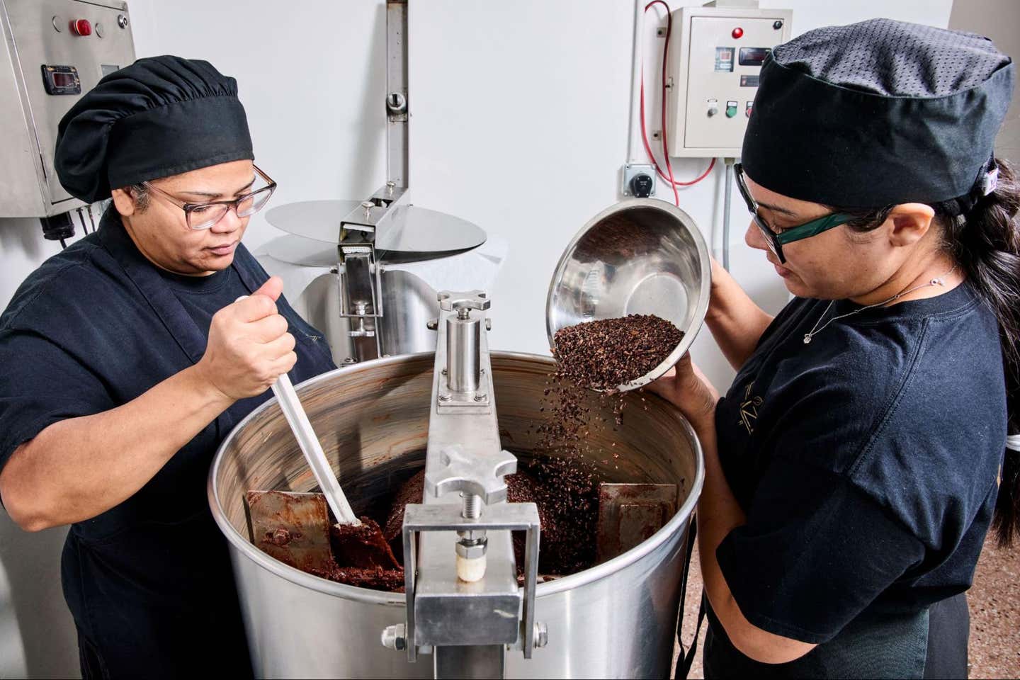 Two cooks showing the process how the chocolate is made.