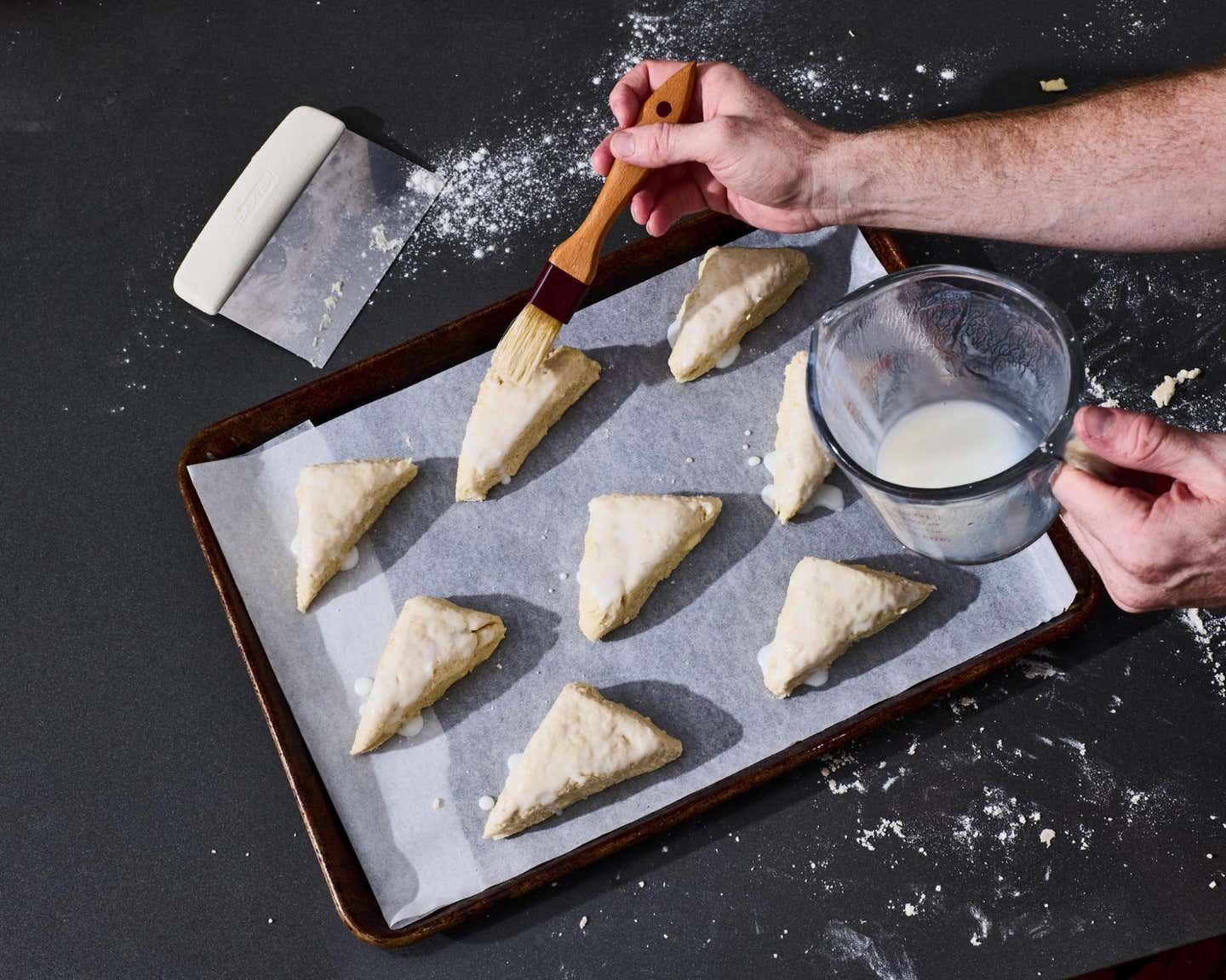Brushing the tops with buttermilk. Brushing the tops with buttermilk.