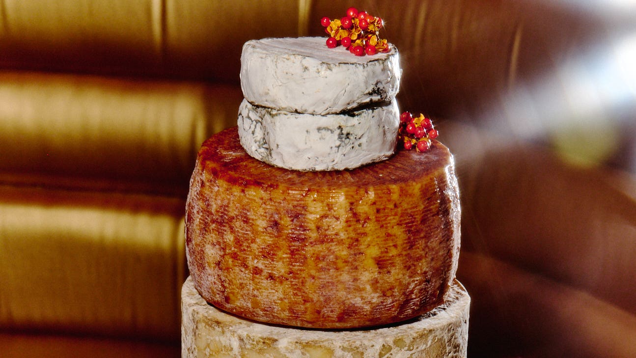 Decorating a layered cake of cheese.