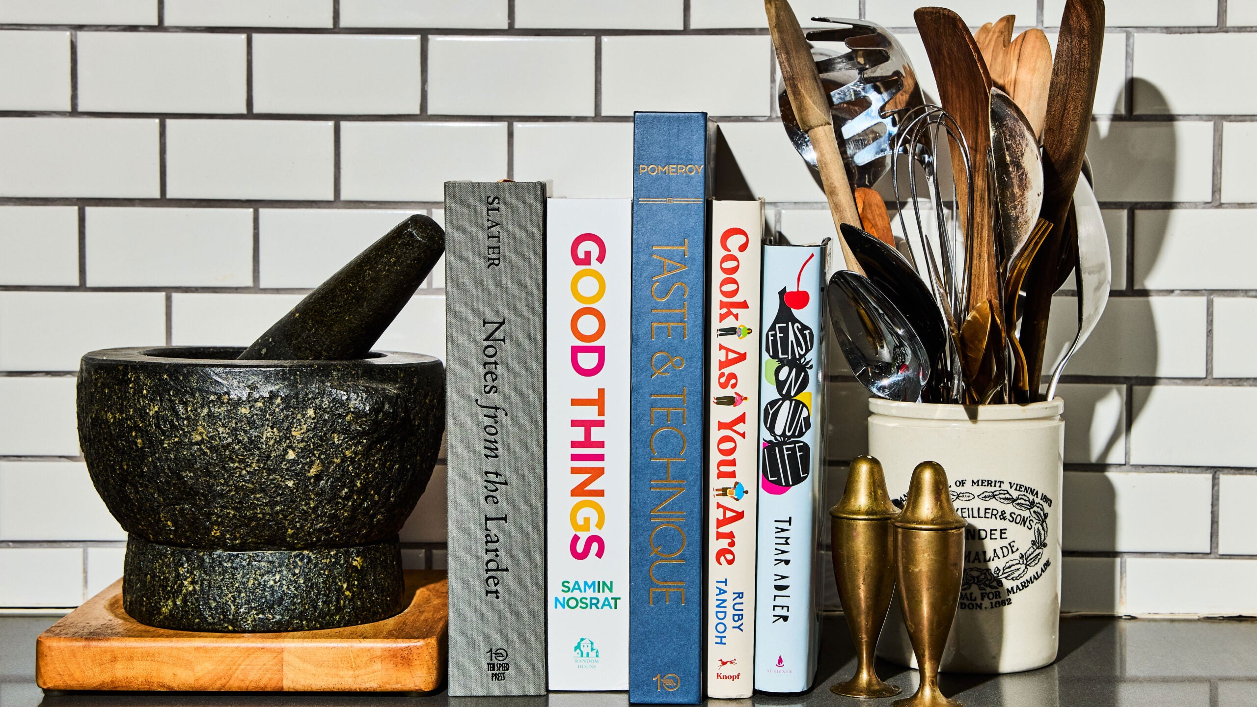 A stack of cookbooks in a kitchen