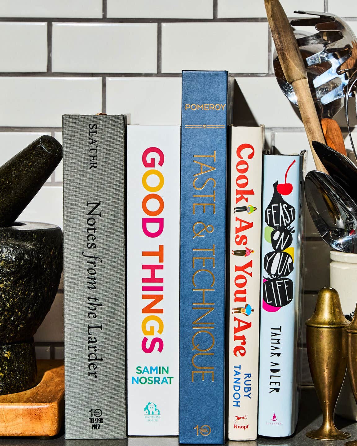 These Cookbooks Explore the Link Between Mindful Cooking and Self-Care A stack of cookbooks in a kitchen