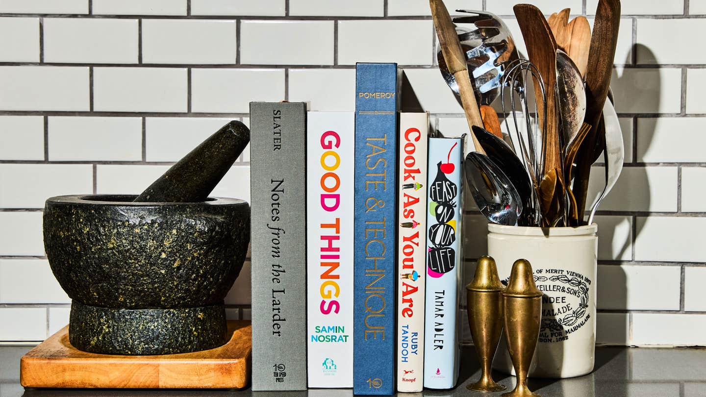 A stack of cookbooks in a kitchen