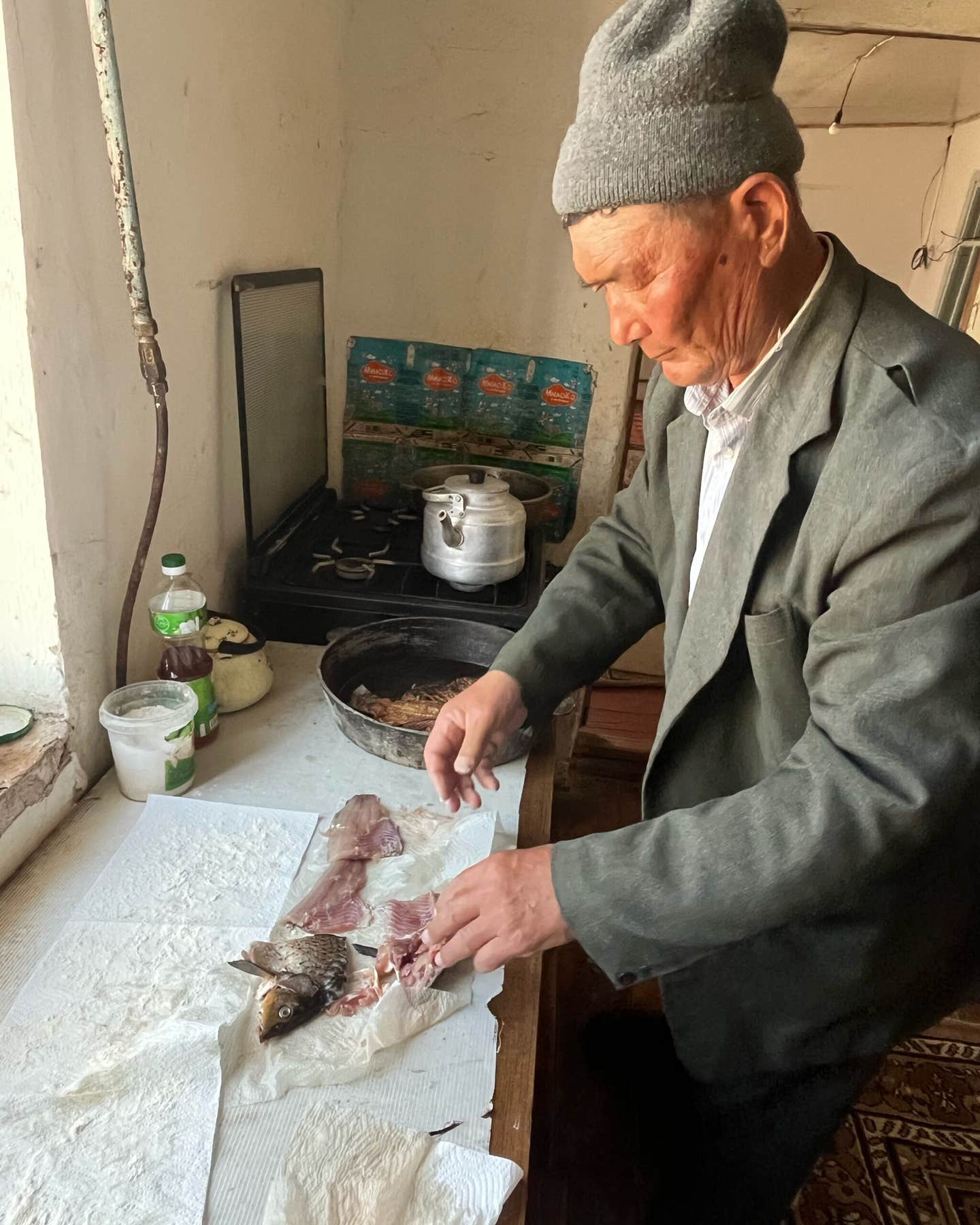 Klishbay Jumanyazov cleans farmed carp purchased at Moynaq’s market, a disappointing replacement for the sturgeon he used to fish as a young man, before the Aral Sea dried up.
